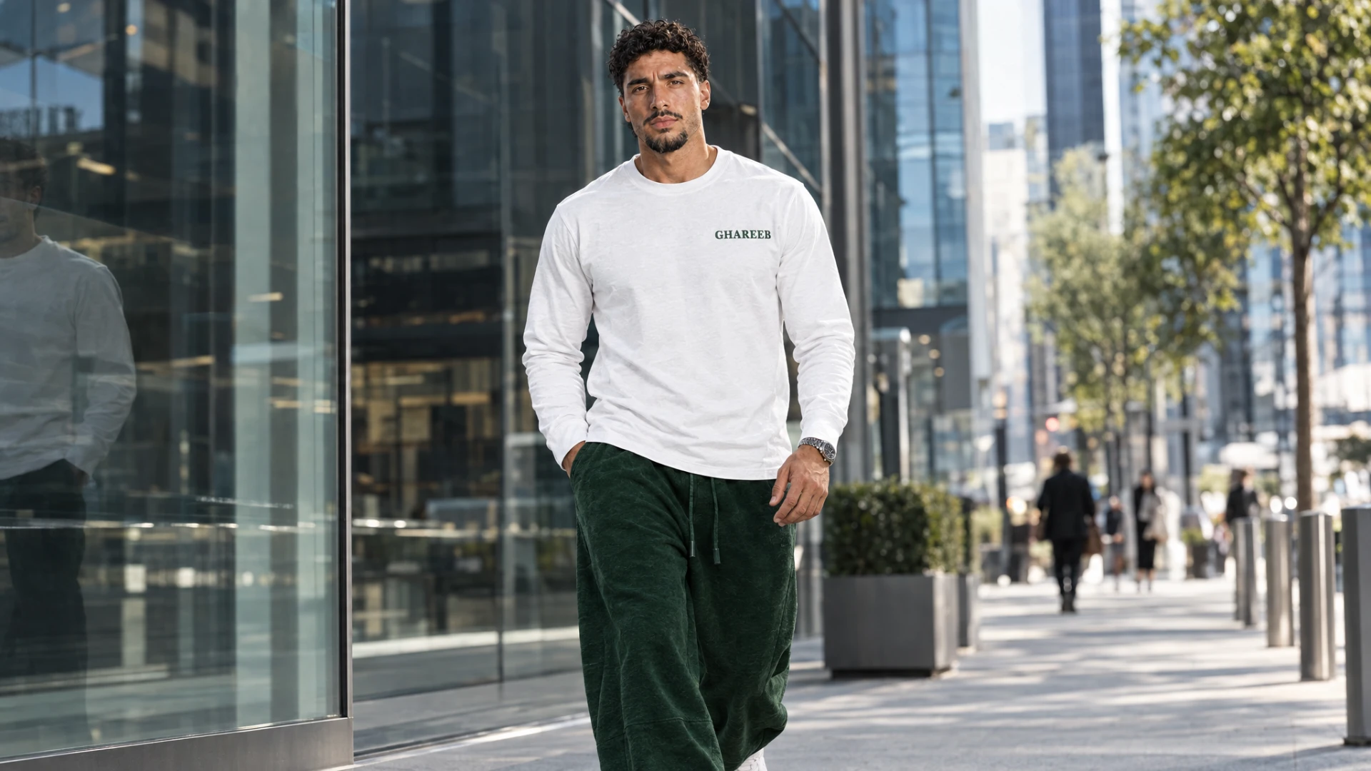 GHAREEB model wearing a white long-sleeve shirt on a city street